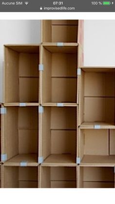 several cardboard boxes stacked on top of each other with blue tape around the bottom half