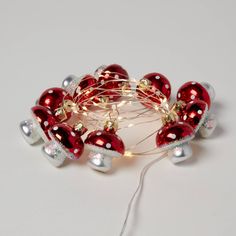 red and silver ornaments with white lights on them