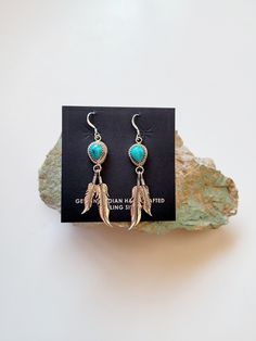 These are a great pair of southwest earrings. These are Navajo handmade they are signed and stamped on the back of the earrings. The artist has used Kingman turquoise that is mined in Kingman Arizona. They have then hung 2 sterling silver feathers that hang down from the stone. These earrings are very light weight and comfortable to wear. The length of the earrings are 2 1/2 inches the width is 1/2 inch. Please message me with any questions you may have. Blue Concho Dangle Earrings, Artisan Turquoise Nickel-free Earrings, Artisan Nickel-free Turquoise Earrings, Handmade Southwestern Drop Earrings, Turquoise Nickel-free Southwestern Earrings, Nickel-free Turquoise Southwestern Earrings, Southwestern Turquoise Drop Earrings, Southwestern Teardrop Concho Earrings, Bohemian Turquoise Concho Earrings