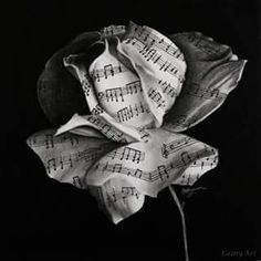 a black and white drawing of a flower with musical notes on it's petals