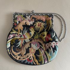 This is an antique or vintage silver mounted silk tapestry  evening bag or purse . The bag frame is stamped 800 silver, features a rose pattern and the piece is probably Dutch. It dates to circa 1920 or 1930. The tapestry features birds and flowers. It has  a clip closure and opens with a push button. It has a chain handle. The lining is grey silk. There is an internal pocket.  Generally good useable condition just a small red pen mark to the lining see photos. 17 x 17cm excluding handle.   We h Antique Tapestry Evening Bag, Handmade Tapestry Evening Bags, Handmade Tapestry Bags For Evening, Vintage Evening Bag In Tapestry Material, Vintage Tapestry Shoulder Bag For Evening, Vintage Tapestry Bag For Evening, Antique Tapestry Bags For Everyday, 1920s Handbag, Silk Tapestry