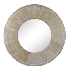 a round mirror sitting on top of a white wall