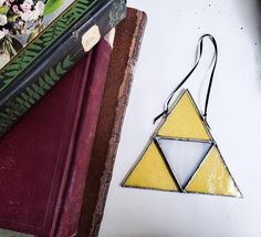 a triangle shaped ornament sitting on top of a book