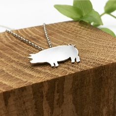 The Silver Pig Necklace has been hand crafted from start to finish in my New Forest based studio. The Pig has been hand pierced and polished for a shine finish.  Dimensions: The Piggy is 1mm thick silver and measures 2.8cm at the widest point.  18inch chain  Hallmarked sterling silver at the Birmingham Assay Office. Please read delivery and returns policy: Delivery  All orders will be sent out using UK Royal Mail signed for delivery and will require a signature. Once payment is complete, I will Silver Minimalist Jewelry With Polished Finish, Minimalist Silver Jewelry With Polished Finish, Minimalist Polished Silver Jewelry, Silver Minimalist Engraved Necklace, Shiny Sterling Silver Jewelry, Silver Necklaces With Shiny Finish For Gifts, Silver Pendant Jewelry With Shiny Finish, Minimalist Engraved Silver Necklace, Silver Necklace With Shiny Finish For Gift