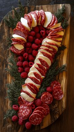 the platter has many different types of food on it, including meats and fruit