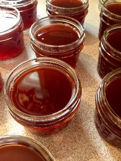 several jars filled with liquid sitting on top of a table