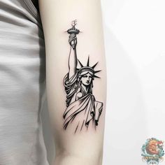 the statue of liberty tattoo on the right arm is shown in black and grey ink