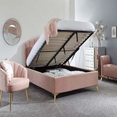 a bed that has been made and is sitting in the middle of a living room