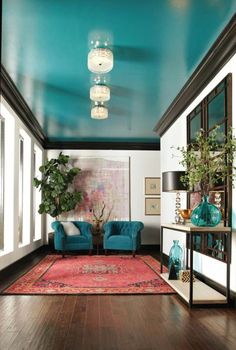 a living room filled with furniture and a blue sky painted on the ceiling above it