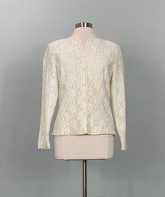 "B E S T  F I T S    Suggested Size: 6/8  Please check measurements below to ensure the best possible fit.      D  E  S  C  R I  P  T  I  O  N     *Beige lace blouse  *Lace has a floral pattern  *Long sleeves   *V-neckline  *There is no stretch to the fabric  *Fully lined  *Buttons up front   *Fitted  *Shoulder pads  *Estimated era: 1990s - 00s      D  E  T  A  I  L  S     *Fabric: No label - possibly synthetic  *Care: No label  *Marked Size: No label  *Maker's Label: No label    M  E  A  S  U Fitted Long Sleeve Cream Lace Top, Classic Fitted Long Sleeve Lace Top, Fitted Crew Neck Top For Wedding, Fitted Vintage Long Sleeve Lace Top, Fitted Long Sleeve Vintage Lace Top, Fitted Vintage Lace Top With Long Sleeves, Classic Fitted Cream Blouse, Classic Fitted Lace Top For Formal Events, Fitted Blouse