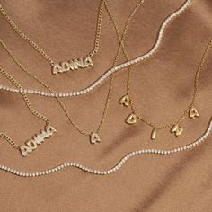 Let the carefree side of your personal style shine bright in Adina's Solid Bubble Name Link Necklace, featuring a cute bubble-font nameplate that dangles from a delicate chain. Customize this gem with the wording of your choice. Pair it with an initial necklace and a couple of cute chokers for a chic, layered look. Product Details Made from Sterling Silver Gold Plated Nameplate Height: 7 MM Chain Thickness: 2 MM Length: 15" +2.5" Capitalized Font This Product Requires 12-18 Business Days To be P