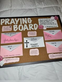 a bulletin board with pink and white envelopes on it that says, praying board