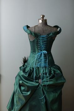 "This stunning handmade Victorian wedding gown was made for an Exhibit in the Springfield WVS art Museum where it was on display for 8 months in 2014. The corset features an emerald jewel toned taffeta hand appliqued with turquoise Indian lace, accented with swarovski crystals and swarovski rhinestones. It is boned with a combination of flat and spiral steel and has a strength layer of German coutil. The over skirt is made of the same taffeta accented with vintage rhinestone and stamped silver j Green Corset Dress With Boned Bodice, Green Wedding Corset Dress, Green Gown With Corset Back And Fitted Bodice, Fitted Green Gown With Corset Back, Green Fitted Ball Gown For Debutante Ball, Fitted Bodice Taffeta Corset Dress For Wedding, Green Fitted Bodice Corset Dress For Wedding, Green Corset Dress With Fitted Bodice For Wedding, Fitted Taffeta Ball Gown For Wedding