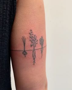 a person with a tattoo on their arm that has carrots and onions on it