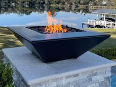 a fire pit sitting on top of a cement block