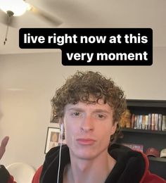 a young man with curly hair wearing headphones