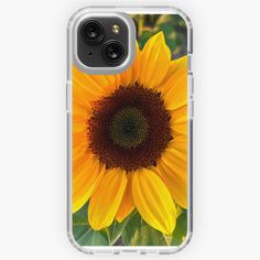 an iphone case with a sunflower in the center and green leaves around it, on a white background