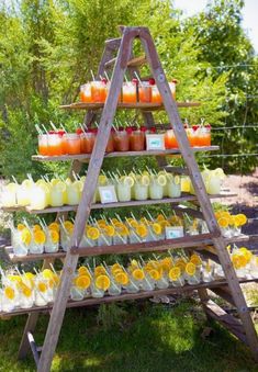 a wooden stand with orange juices and lemonade cups on it's sides