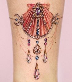 a woman's leg with an elaborate tattoo on it