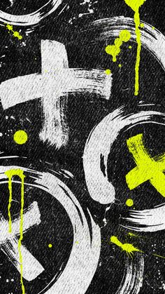 yellow and white paint splattered on black paper with an x symbol in the middle