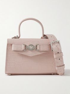 Versace's mini bag is adorned with the house's signature 'Medusa' logo, which the founder plucked from the ancient ruins of Italy's Reggio di Calabria. Made from croc-effect leather, it has a detachable shoulder strap and compact silhouette sized to fit your keys, cards and a favorite lipstick. Versace Bag, Versace Pink, Lavender Bags, Versace Bags, Ancient Ruins, Strap Top, Cute Bags, Designer Bags, Bag Straps