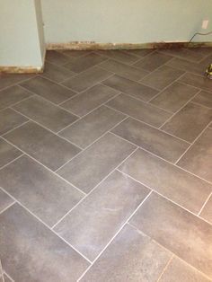 an empty room with a tile floor that has been cleaned and is in the process of being remodeled