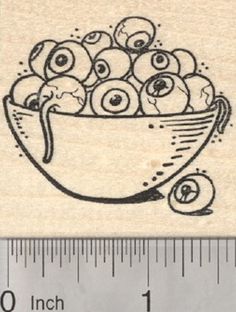 a rubber stamp with an image of a bowl of apples on it and a ruler