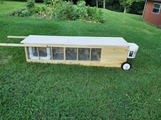 a toy bus sitting on top of a lush green field