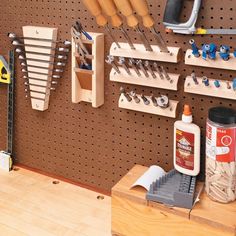 a pegboard with many tools hanging on it