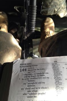 an open book sitting on top of a table next to a person's feet