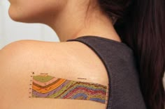 a woman with a colorful tattoo on her shoulder