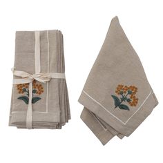 four linen napkins with embroidered flowers on them