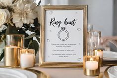 a wedding sign with candles and flowers on the table