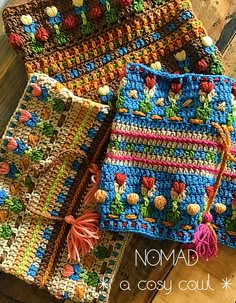 three crocheted bags sitting on top of a wooden table