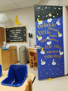 a classroom with two blue chairs in front of a chalkboard that says twinkle little stars