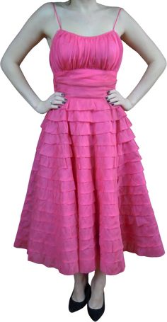 Love Love this DressLayered, Layered SkirtRuched Waist Pleated BodiceLined layer, tulle layer and then full circle skirtSide ZipperThis color is AMAZING, Vibrant, Bright PinkMODEL'S MEASUREMENTS FOR COMPARISON (when we have one) ARE AS FOLLOWS34" BUST ~ 26" WAIST~ 35" HIPS SHE IS 5"6"APPROXIMATE MEASUREMENT GARMENT MEASURED LAYING FLATShoulder: 9"Bust: 16. 5"Waist: 13. 5""Hips: openSleeves: n/aLong: 47. 5" shoulder to hemBased on the chart below I rating this in Excellent Condition skirt Tiny mark on 3rd layer up from the bottom. may lift given a soak, regardless this dress is spectacular Condition Chart Mint: An item is as perfect and pristine as when it was originally made and shows no sign of wear (mint condition is rare for clothing) .Near mint: An item shows only the slightest signs o Fitted A-line Skirt With Ruffles, Pink Tiered Skirt Dress For Cocktail, Pink Tiered Skirt Cocktail Dress, Full Skirt Prom Dresses With Ruffles, Pink Tiered Dress With Voluminous Skirt, Retro A-line Skirt For Party, Pink Tiered Voluminous Dress, Pink Flowy Dress With Lined Skirt, Pink Voluminous Tiered Dress