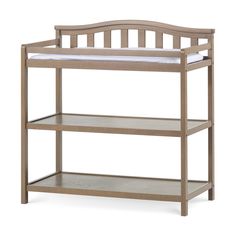 a baby crib with two shelves and a mattress on it's bottom shelf