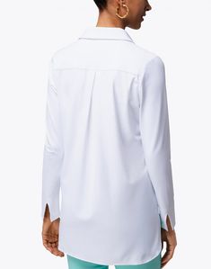 For effortless, everyday dressing, Jude Connally's Hadley henley offers a fresh take on the classic tunic top. This crisp white top is crafted from their signature Jude cloth fabric, and features a feminine henley neckline, pleated back, and an asymmetrical hem. Style it with your well-loved denim and a leather handbag for a modern daytime look.