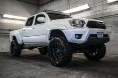 a white truck is parked in a garage