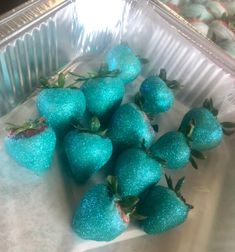 some strawberries are sitting in a tin foil container