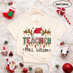 "Teacher Personalized Christmas Shirt, Teacher Custom Xmas Shirt, Teacher Name Shirt Xmas, Teacher Sweatshirt, Teacher Gift, Teacher Santa ↓ See the rest of our trendy collections here ↓ https://www.etsy.com/shop/tranhuynhduc Product Details: 100% Cotton (fiber content may vary for different colors) Medium fabric (5.3 oz/yd² (180 g/m Classic fit Tear away label Runs true to size Care instructions: Machine wash: warm (max 40C or 105F); Non-chlorine: bleach as needed; Tumble dry: medium; Do not ir Christmas Shirts For Teacher, Christmas Cricut Shirts, Christmas Shirts For Teachers, Teacher Christmas Shirts, Personalized Christmas Shirts, Teacher Custom, Clothing Crafts, Teacher Sweatshirt, Teacher Personalized