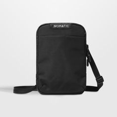 a black bag with the word nomadic on it and a strap around it