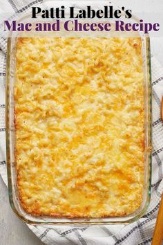 a casserole dish with cheese in it on a towel next to utensils