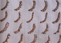 many different designs are shown on a piece of white paper with brown lines and swirls