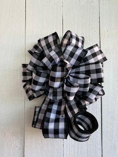 a black and white checkered bow hanging on a wall