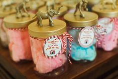 small jars filled with pink and blue marshmallows