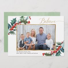 a christmas card with holly and berries on the front, featuring an image of a family