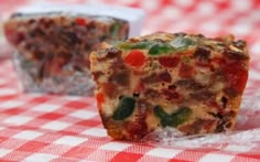 two pieces of food sitting on top of a red and white checkered table cloth