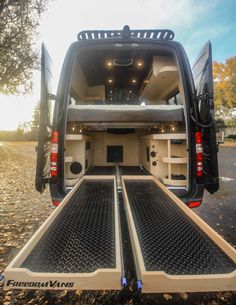 the back end of a white van with its doors open