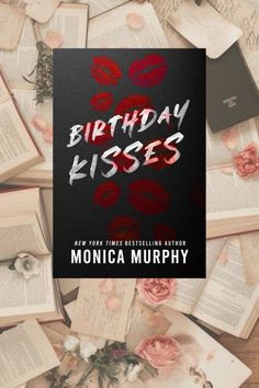 the cover of birthday kisses by monica murphy is surrounded by old books and pink flowers